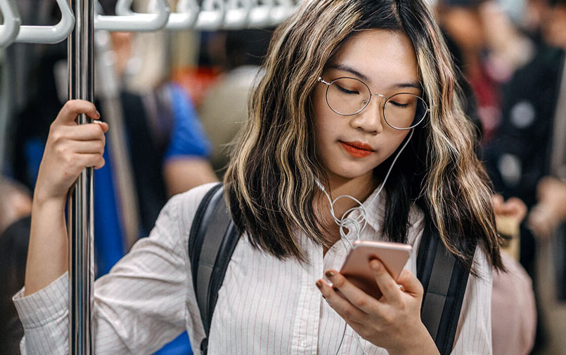 Girl using a phone while in a train