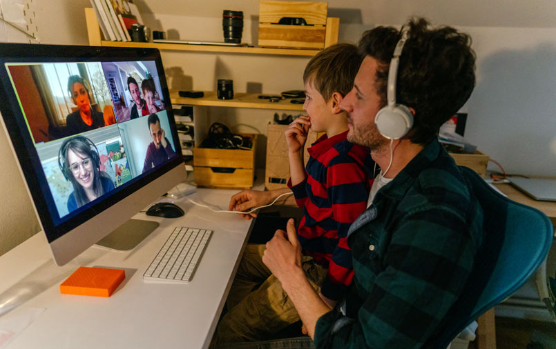 Father and son joining an online video conference