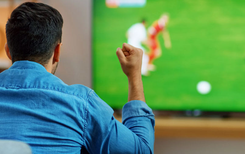 Man watching sports on TV