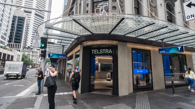 People standing in front of the Telstra store in the Sydney CBD