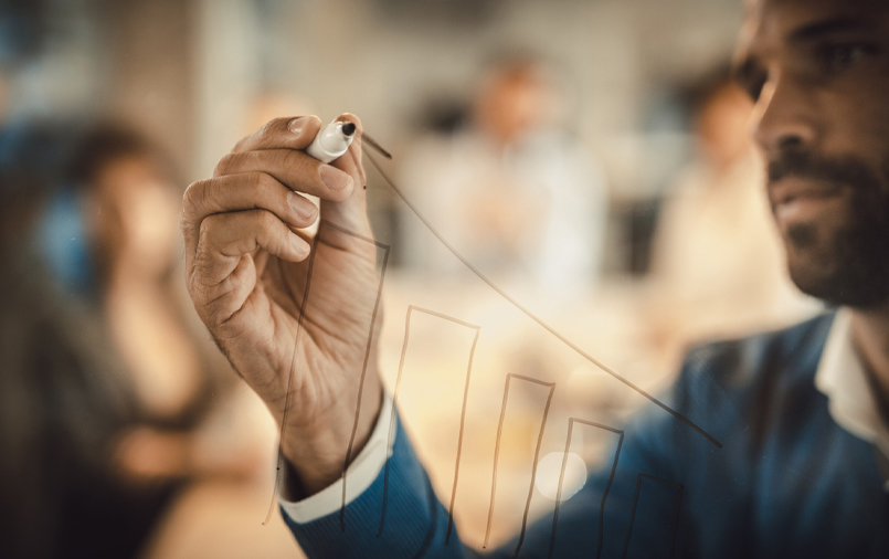 A man drawing a bar graph