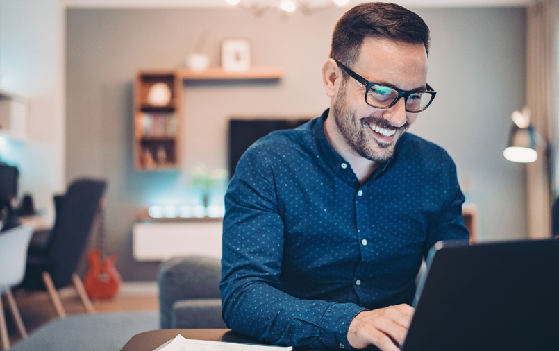 Man happily using his laptop