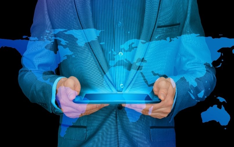 Man holding tablet with overlay of the world map
