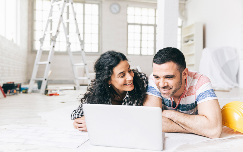 Happy couple using a laptop