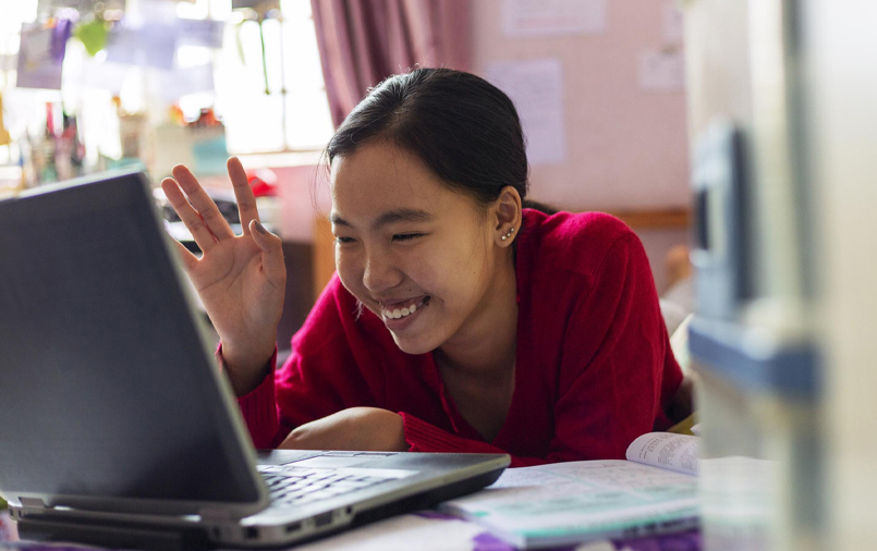 Woman saying hi over her friend in the Internet