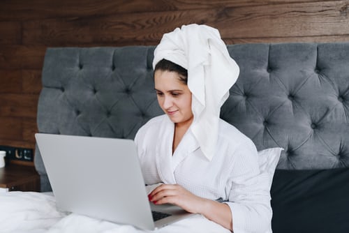 woman in bed using the internet