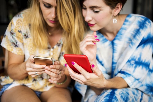 women look at internet on their smartphones