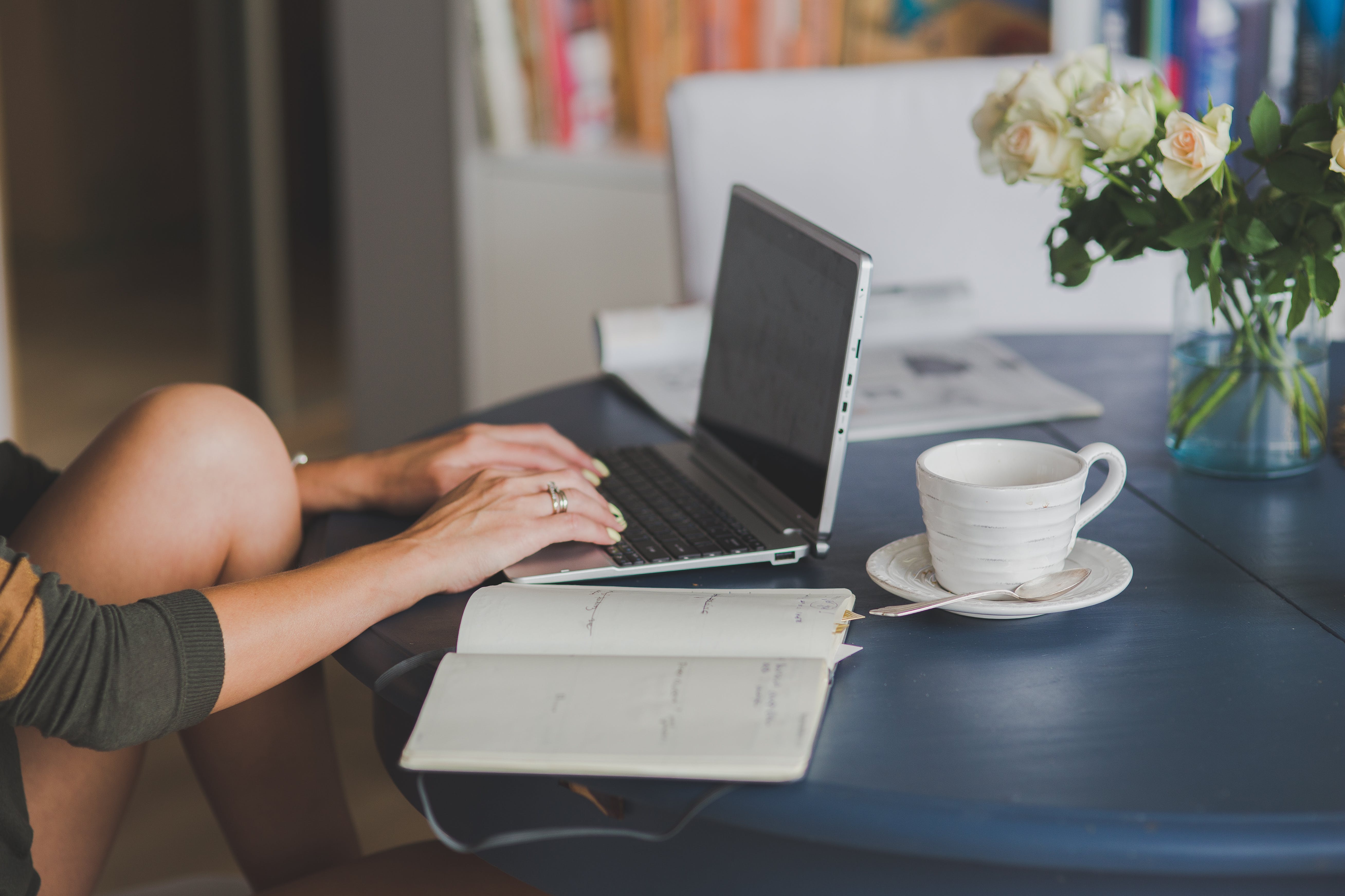 Woman drinking coffee on laptop